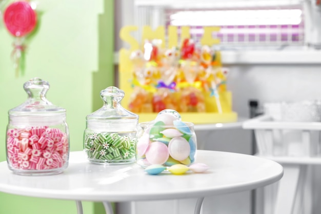 Different sweets in jars at candy shop