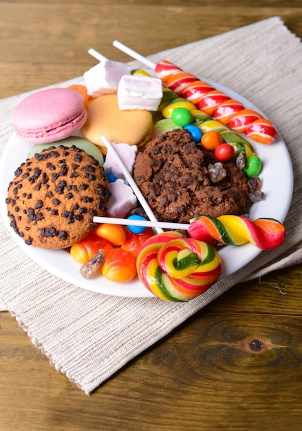 Different sweets on plate on table close-up