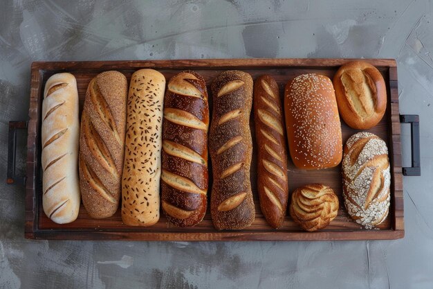 Different types of bread loaves lying on wooden tray