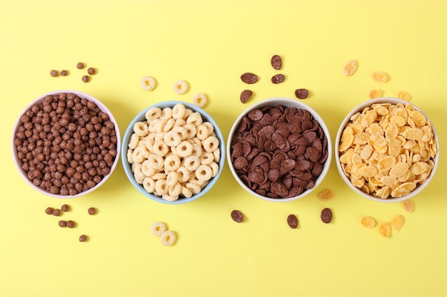 Different types of breakfast cereals on a light background closeup