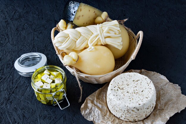 Different types of cheese on a black background. Cheese platter