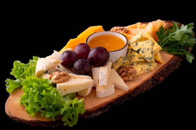 Different types of cheese isolated on a black