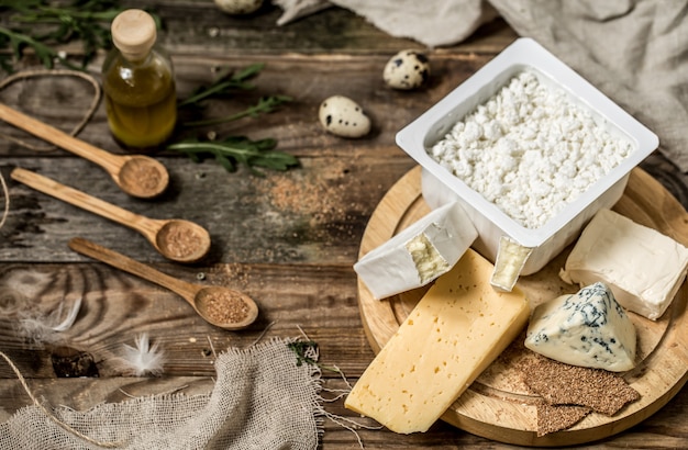 Different types of cheese on wooden background ,composition, delicatessen ,concept and gourmet cheeses