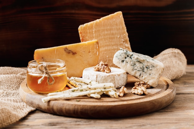 Different types of cheeses. slices of cheese brie or camembert with parmesan