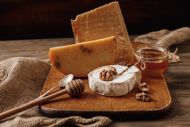 Different types of cheeses. slices of cheese brie or camembert with parmesan