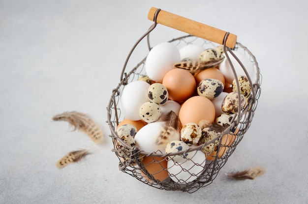 Different types of eggs in a basket.