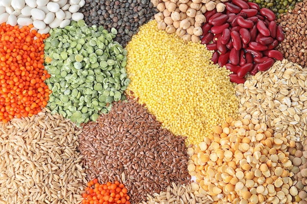 Different types of legumes and cereals as background top view Organic grains