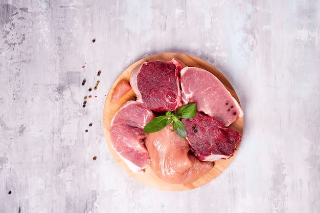 Different types of meat on a wooden board. Lean proteins.