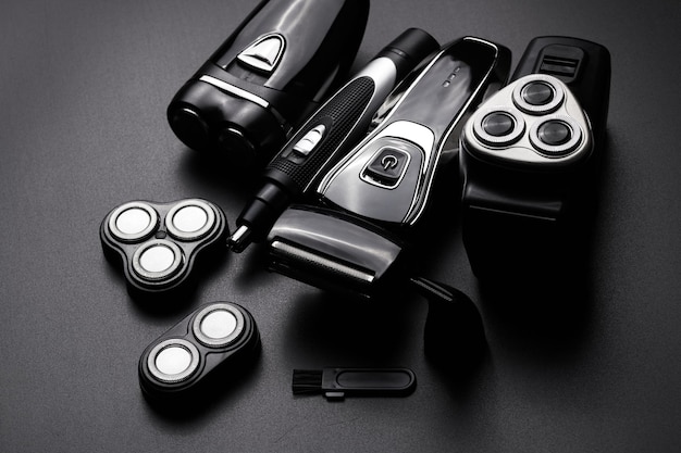 Different types of men's electric razor closeup isolated on black background