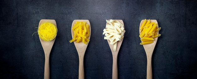 Different types of pasta on a dark background