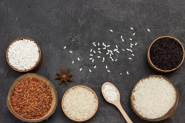 Different types of rice in wooden bowls. Flat lay.