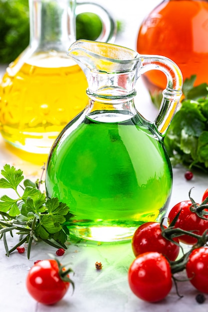 Different types of vegetable oil in glass bottles: sesame, linseed, grape oil.