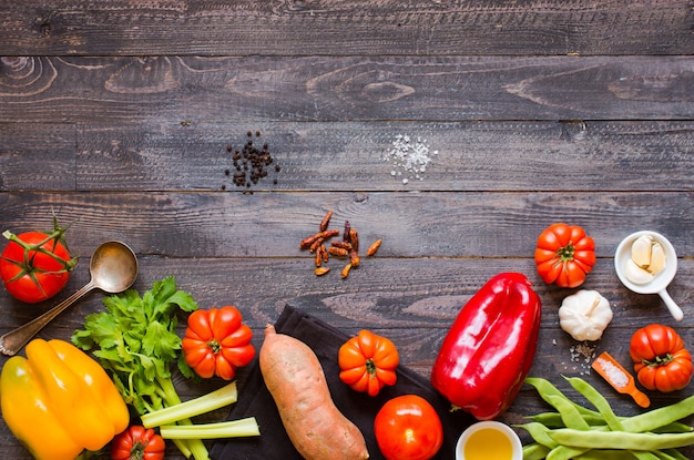 Different types of vegetables, on a old wooden table, space for text.