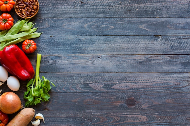 Different types of vegetables, on a old wooden table, space for text.