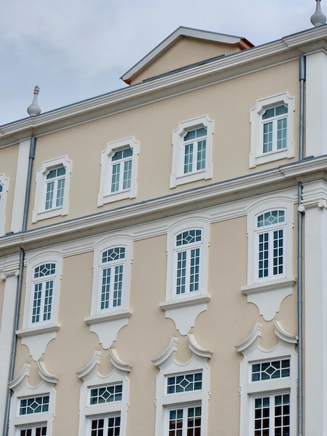 Different windows decorated by stucco molding on the facade of classical Portuguese building facade in Aveiro old center Portugal