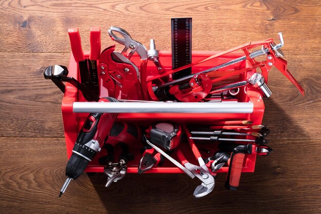 Photo different worktools in toolbox on wooden desk