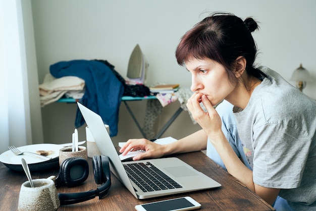 Digital addiction, woman in panic reads articles about coronavirus on Internet,