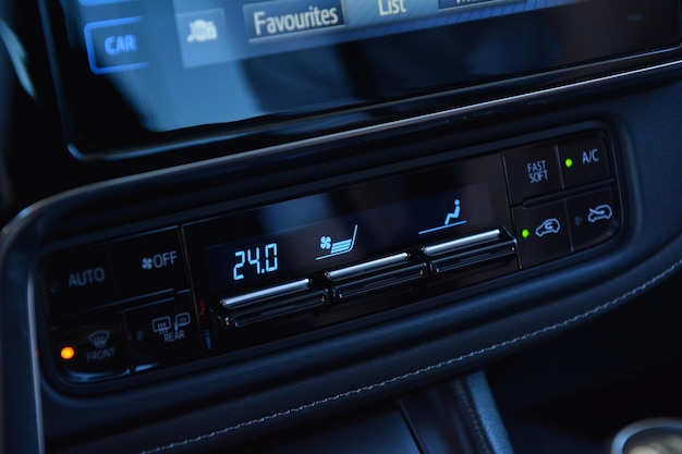 Photo digital air conditioning and ventilation controls on the dashboard of the car