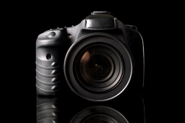 Digital camera on black background.