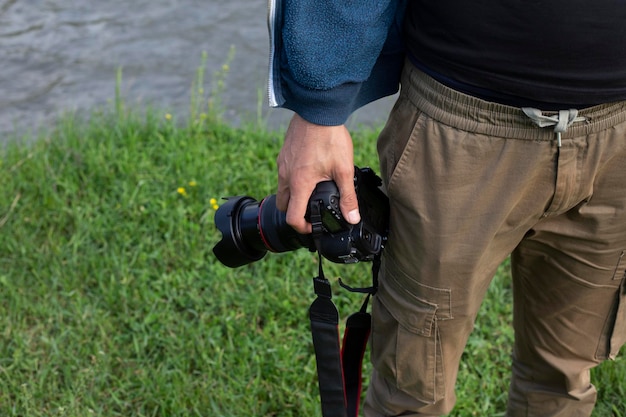 digital camera in man hand nature background