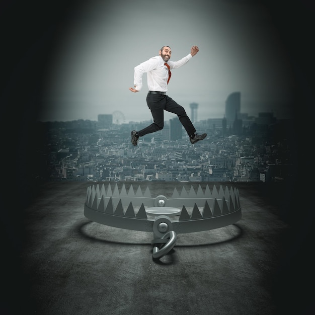 Photo digital composite image of businessman jumping over mousetrap in city