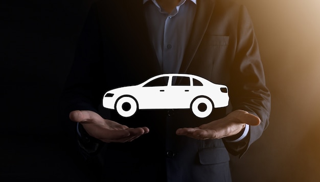 Digital composite of Man holding car icon.Car automobile insurance and car services concept. Businessman with offering gesture and icon of car.