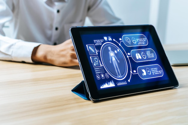 Digital mobile tablet with digital icon hologram and medical graphic diagram on screen with patient in hospital coronavirus medical technology health care cancer and disease treatment concept