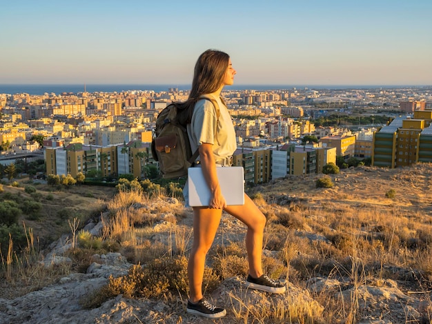 Digital nomad girl who travels the world working with a laptop