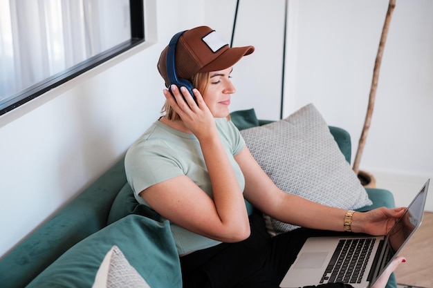 Digital nomad woman relaxing listening to music while working remotely Concept teleworking lifestyle