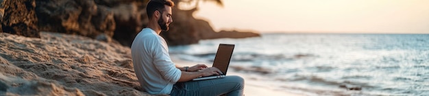 Digital Nomad Working on His Laptop Outdoors from the Beach