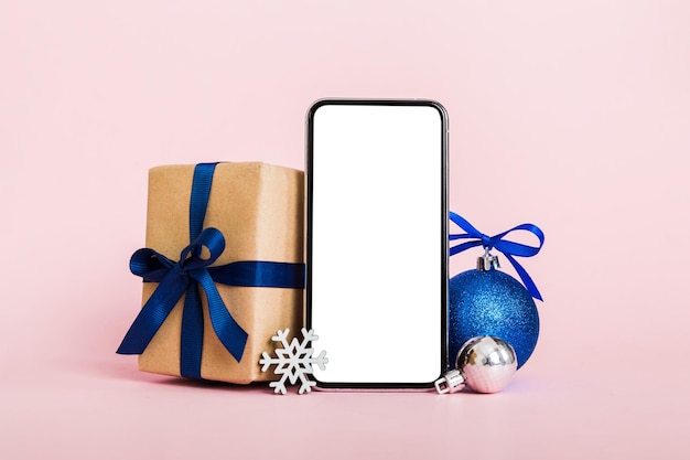 Digital phone mock up with rustic Christmas decorations for app presentation with empty space for you design Christmas online shopping concept Tablet with copy space on colored background