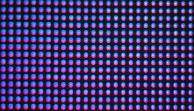 Digital screen background. Color screen monitor or TV with glitch pixels and LEDs close up.