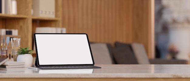 Digital tablet mockup and copy space on white tabletop over blurred living room in background