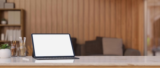 Digital tablet mockup with wireless keyboard and copy space on tabletop over blurred living room