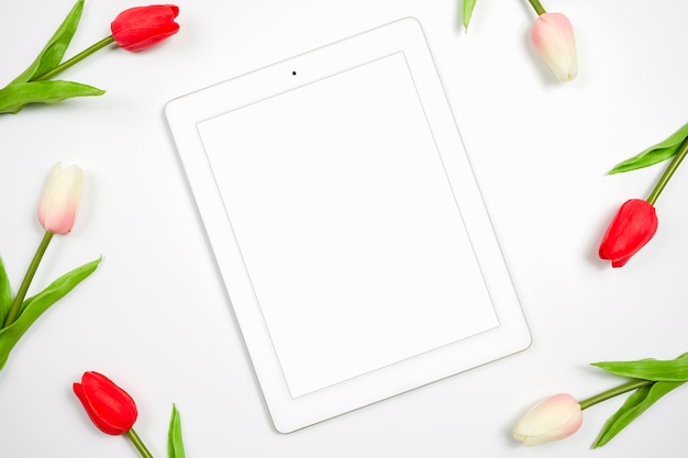 Digital tablet white screen for mockup with beautiful tulip on white background