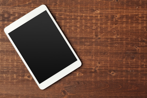 Digital tablet on wooden table