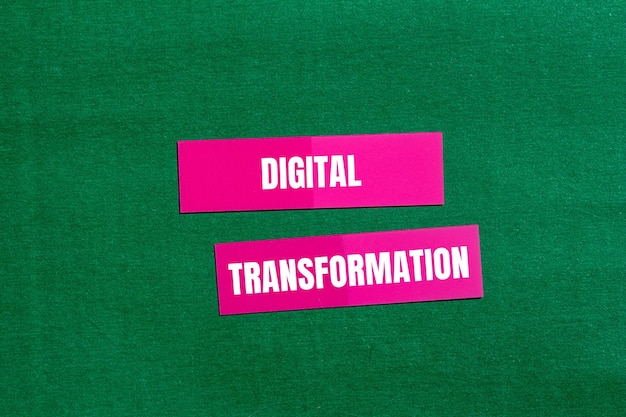 Photo digital transformation message written on pink paper with green background conceptual digital transformation symbol copy space