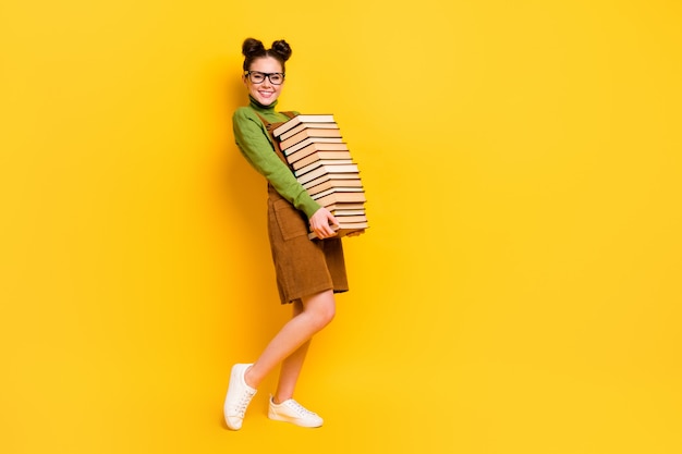 diligent cheerful girl nerd carrying many book back to school 1 September autumn
