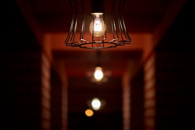 Dim light bulbs in the dark corridor.