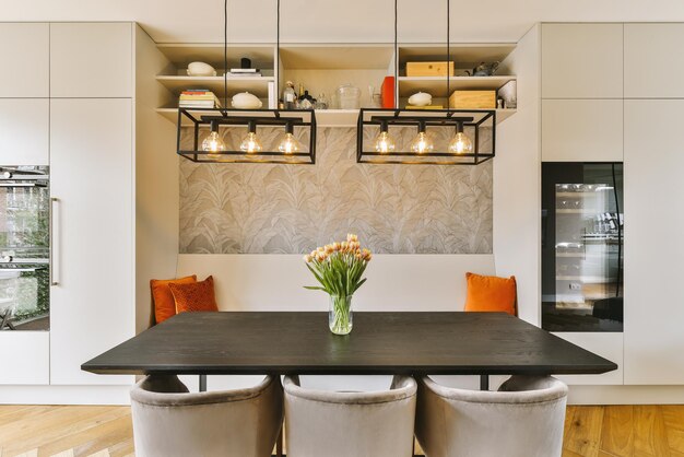 A dining room with a black table and four chairs