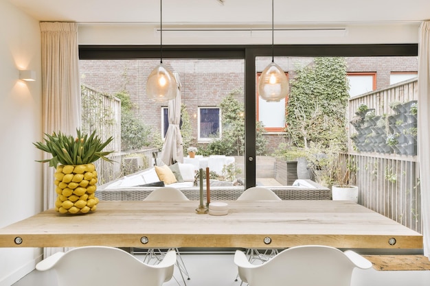 A dining room with a large table and a window