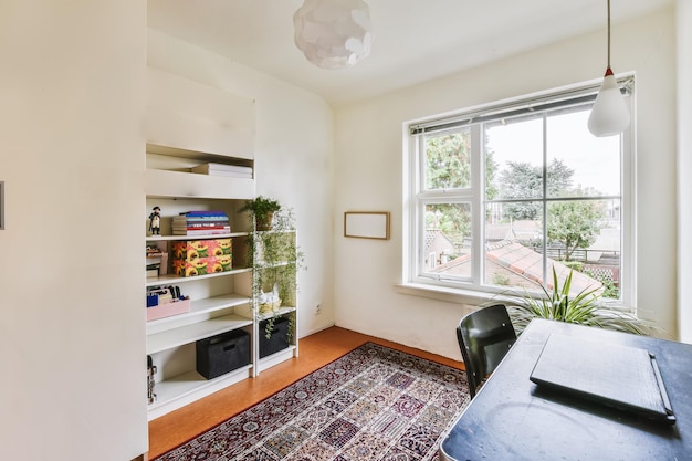 A dining room with a large window and a table