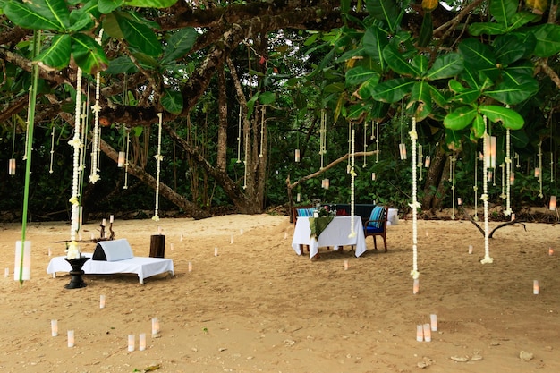 Dining table set up for romantic date on sandy beach