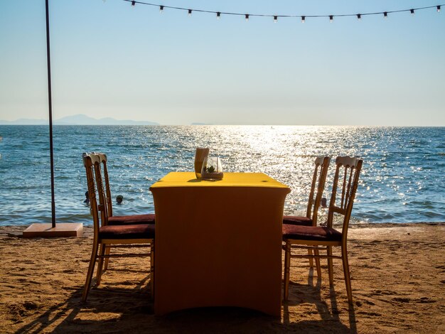 Dining table with four chairs on the beach