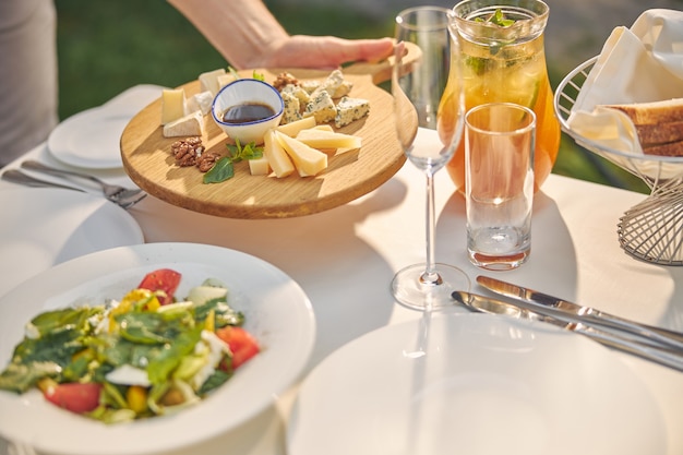 dining table with orange lemonade and tasty delicious meal for honored guests