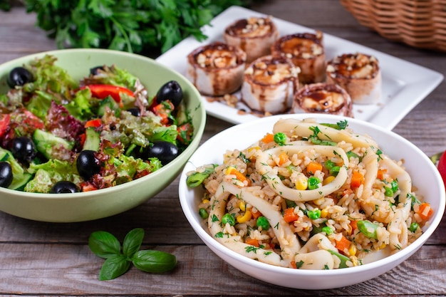 Dinner: salad, fried squid with rice and dessert on the table