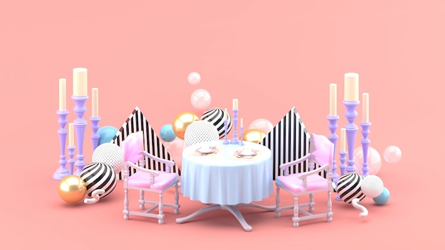 Dinner table and candle holder among colorful balls on pink space