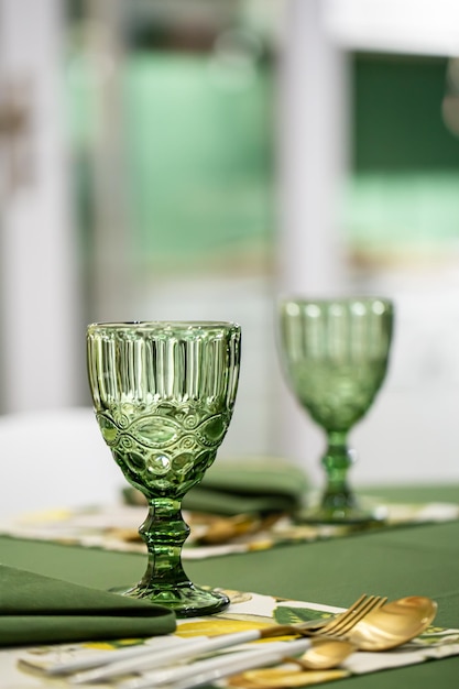 Dinner table setting idea with textured green glass goblets