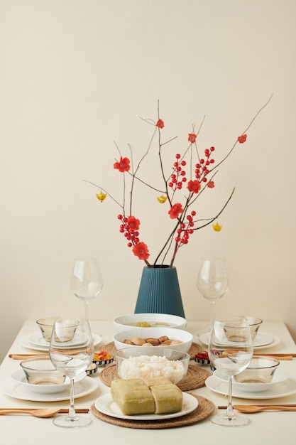 Dinner table with food and glassware served for lunar new year celebration