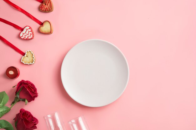 dinner for Valentine's Day on pink background. View from above.